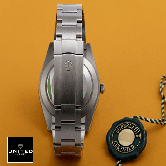 Rolex Oyster Perpetual 124300 Rolex Perpetual 124300 Stainless Steel Oyster Bracelet Replica Fold Clasp on the Rolex Logo and Orange Background