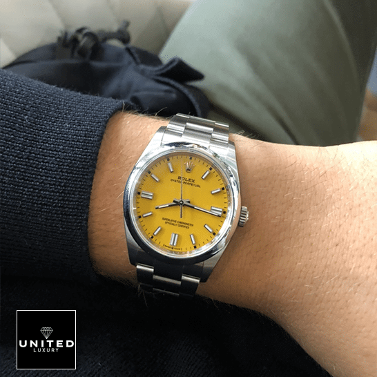Rolex Oyster Perpetual 124300 Rolex Perpetual 124300 Yellow Dial Stick indices Replica on his arm